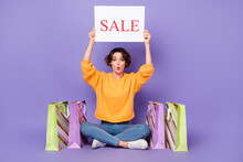 Portrait Of Attractive Amazed Girly Funny Girl Holding Sale Board New Advert Offer Isolated Over Violet Lilac Color Background