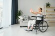 © Serhii - Brunette woman working out on wheelchair at home