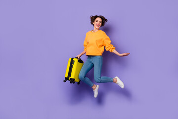 Poster - Full length body size view of attractive cheery girl jumping holding bag resort departure isolated over violet lilac color background