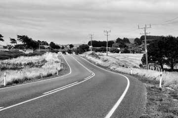 Sticker - New Zealand South Island rural road. Black and white retro photo style.