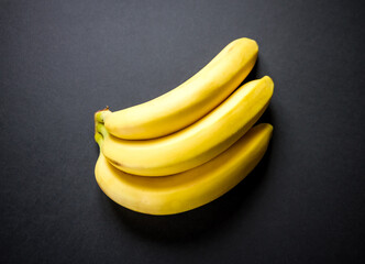 Wall Mural - Bunch of bananas isolated on black background