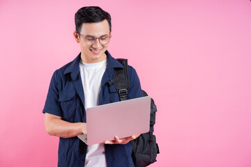 Wall Mural - Image of young Asian college student on pink background