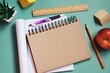 © learesphoto - Back to school concept flat lay composition photography. Paper notebook, purple pen, pencil, wooden ruler and red apple on a green table. Mockup, free space for text