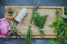 Various Herbs Picked From The Garden, Getting Ready For Drying, On Wooden Background