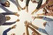 canvas print picture - Team of business people reaching up together. Group of young and mature people joining hands, white background, cropped low angle shot, from below bottom view close up. Teamwork, participation concept