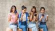 © Phushutter - Group of Asian female friends using cellphones, feeling happy, win, victory.