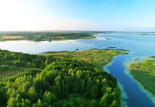Lake In Wild Nature, Aerial View. Lake On Sunset In Summer. Aerial Panoramic Landscape View Of Lake In Wildlife. Drone View Of Wetland In Green Colors. Rural Environment, Clean Air And Ecology. Pond.
