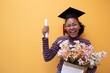 © Chalermphon - Pretty African american woman with black hair graduate bechalor degree.Education successful university college woman smiling  achievement Academic graduate.Isolated person yellow blackground design.