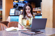 © ivanko80 - Woman using laptop at cafe