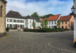 Beautiful picturesque historic suburban residential area Kaiserswerth near Dusseldorf, Germany a with litte side and backstreets, house facades, cars and lush vegetation in gardens and flower boxes	