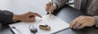 © Puwasit Inyavileart - Female attendant handed over the rental car key to the customer who signed the contract and the terms of the agreement on the document, Car rental service concept.