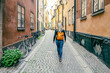 © pyty - Young woman in the street of Stockholm Old Town