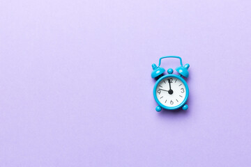 Alarm clock isolated on colored background with copy space top view