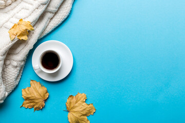 Wall Mural - flat lay composition with colorful autumn cup of coffee and leaves on a color background. top view