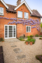 House And Garden Design With Patio, French Doors, Wisteria, UK
