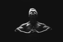 Handsome Power Athletic Man In Dramatic Light. Strong Bodybuilder With Perfect Shoulders, Biceps, Triceps, Back, Delta And Chest. Strength And Motivation