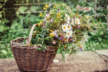 Bouquet Of Wild Flowers With Daisies In A Wicker Basket. Summer Still Life