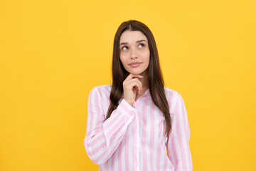 Portrait of young woman thinking, looking up empty space. Thoughtful serious model in studio looking away. Girl thought choose decide solve problems.