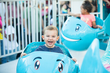 Happy toddler laughing and enjoying fair ride