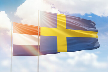 Wall Mural - Sunny blue sky and flags of sweden and netherlands