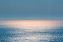 Abstract Landscape. Blue Background. Serene Ocean Water And Sun Light