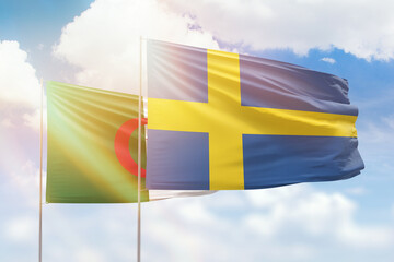 Sunny blue sky and flags of sweden and algeria