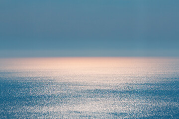 abstract landscape. blue background. serene ocean water and sun light