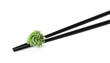 Chopsticks with swirl of wasabi paste isolated on white