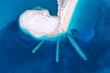 Aerial view of sandbank with breakwater at sunset in Lefkada, Greece. Top view of white sandy beach and blue sea. Landscape with sea shore, clear azure water. Nature. View from above. Ionian Islands