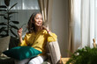 © wattana - Middle aged woman resting on comfortable couch, looking away thinking dreaming enjoy stress free peaceful mood wellbeing alone in living room.