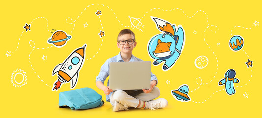 Canvas Print - Little schoolboy with laptop on yellow background with drawn space