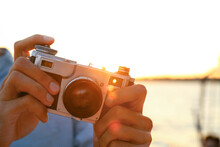 Hands Of Young Man With Vintage Photo Camera On Sunny Day