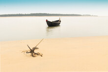 Moody Image Of A Boat On Water Tied By A Rope With An Anchor On River Bed At Tajpur, West Bengal, India. Minimalistic Image.