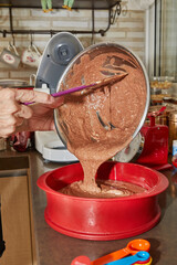 Wall Mural - Chef pours the pie ingredients from the bowl into silicone baking dish