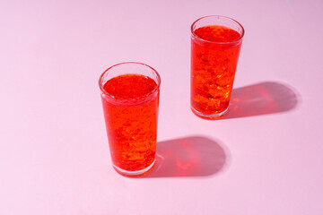 Refreshing pink punch cocktail on color background