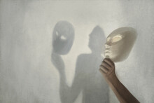 Surreal Shadow On The Wall Of A Person Who Takes Off The Mask From His Face, Concept Of Truth And Fiction