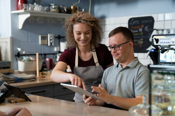 Caucasian man with down syndrome learning how to take orders