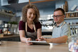 © gpointstudio - Caucasian man with down syndrome learning how to take orders on digital tablet