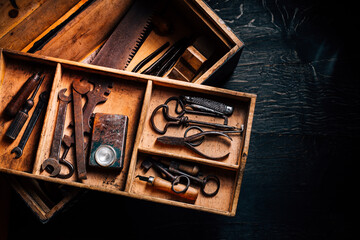 collection of vintage carpentry tools in old wooden chest: woodworking, craftsmanship