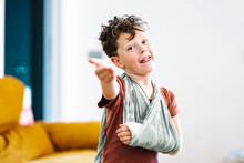 Boy With Broken Arm Making Inviting Gesture