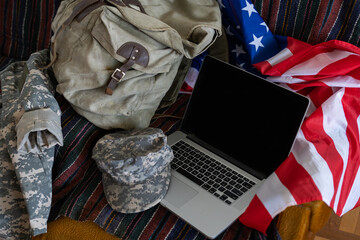 American flags with laptop. military cap