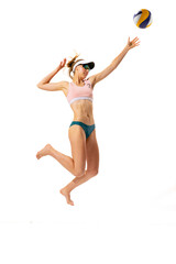 studio shot of one fitness young woman, volleyball player in sports swimsuit playing bach volleyball