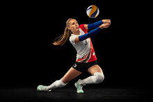 Dynamic Portrait Of Professional Volleyball Player In Sports Uniform Playing Volleyball Isolated On Dark Background. Sport, Healthy Lifestyle, Team, Action, Motion Concept