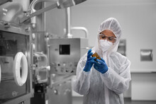 Female Scientist Holding Medicine In A Drug Manufacturing Laboratory