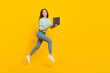 Leinwandbild Motiv Full size profile side photo of charming good mood casual wear businesswoman browising in netbook isolated on yellow color background