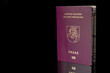 Front face of a Lithuanian passport. Black background