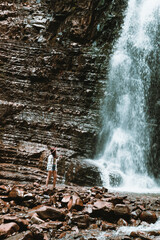 Poster - woman traveler enjoying view of waterfall