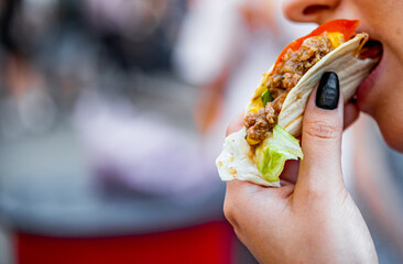 woman eat taco outdoor traditional in mexican food. street food