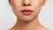 Cropped of asian lady showing her beautiful soft lips, posing over white studio background, closeup shot