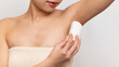 © Prostock-studio - Closeup of young lady applying deodorant antiperspirant on armpit, standing over white studio background